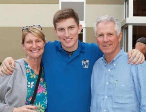 Justin recently posed with his parents, Martina Mahly and Jay Addison, in front of LaSalle Hall.