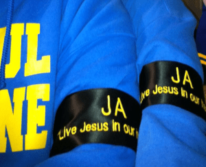 This year, band members are wearing black arm bands for all parades in memory of fallen student, Justin Addison, that read, "JA, Live Jesus in our hearts forever."
