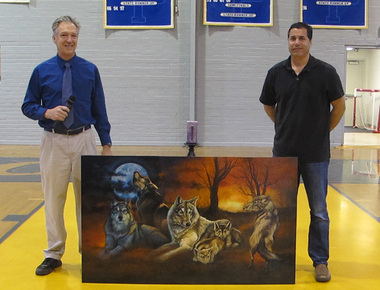 Biology instructor John Carambat and generous donor Kraig Schexnayder pose with the lastest addition of art to the St. Paul's campus.