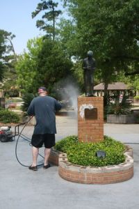 A parent cleaning up the campus after the vandalism. (Photo courtesy of The Covington Police Department)