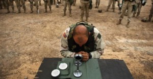 A military priest celebrates the mass for his fellow troops. (Photo by Steve Skojec)