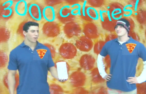 Two pizza-loving students pose for a photo.