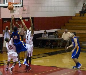 Rico Bedford attempts a layup in a game last year as Patrick Voelker looks on. Both Bedford and Voelker graduated last year.