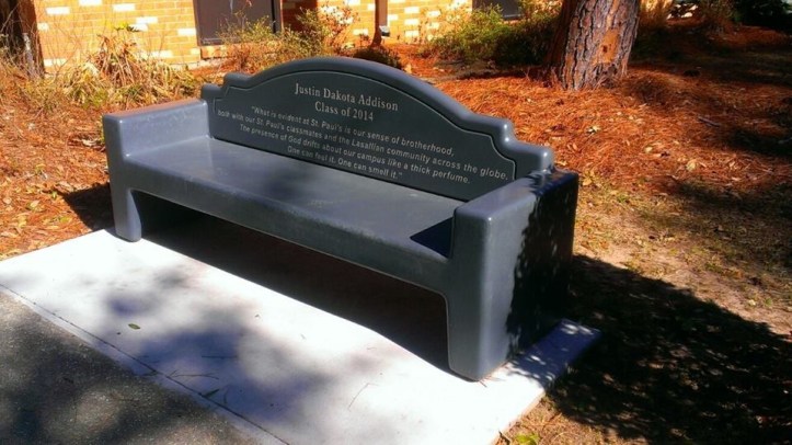 A bench bearing one of Justin's favorite quotes sits near the chapel as a memorial. (photo by Kole Gorney)