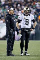 Saints coach Sean Payton and Drew Brees talking after a Brees interception. (photo by Matt Rourke)
