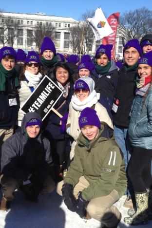 Purple hatted participants from the Arch-Diocese prepare for the March.  SPS students depicted, top L toR, senior Christian Caragliano, senior Michael Brown, senior Jacob McWilliams, senior Thomas Huval, and senior Michael Stewart, bottom L to R, freshman George Lee, senior Ben Kenney. Photo by Liz Carter.