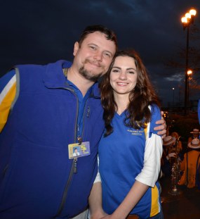 SPS Band Director and his wife, Ukrainian native Yana Obolenskaya, prepare to take the Marching Wolves through the streets of New Orleans for the Bacchus parade. (photo by Nary Cannon)