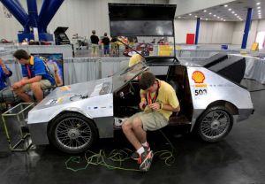 Marcus Garner works on the turn signals on the DeLoreon at the Houston Events