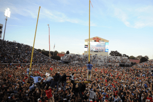 Ole Miss fans storm the field after the Rebels dramatic win over the Alabama Crimson Tide. In the process of tearing down the fist goalpost. (Photo Credit: CBS Sports) 