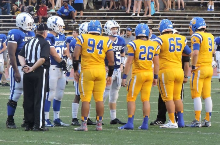 Team captains head to mid-field for the coin toss to begin the game.