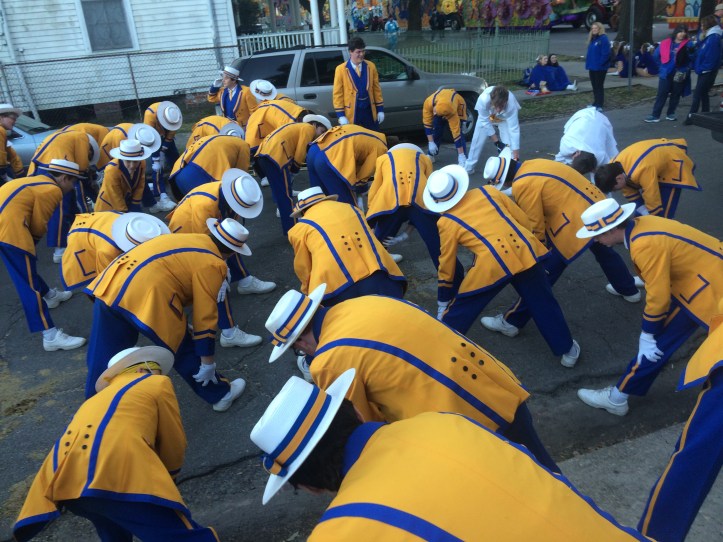 The St. Paul's Marching Wolves stretch before marching in a Mardi Gras parade to get prepared. (Photo by Christi Simoneaux)