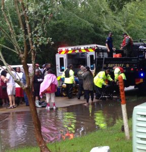 An ambulance tends to victims in the wake of the flood. (Photo by Landon Chambliss)