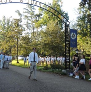 Legacy senior Spencer Cole, son of 1985 alumnus Ernie Cole, marches through the arch and down De La Salle Drive amidst family and the SPS student body. (photo by Danielle Lavie) 