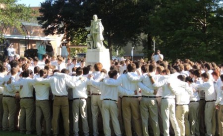 After marching through the arch, the senior class gathers around the statue of St. John Baptist de la Salle to sing the school fight song and anthem "Rise Up O Men of God." (photo by Danielle Lavie)