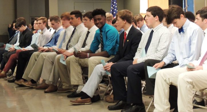 TJ Bedford (center) smiles after receiving his ring. <br>(Photo by Mimi Montiero)